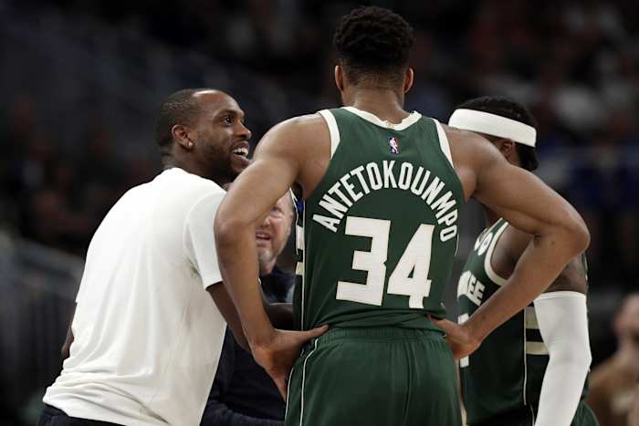 Milwaukee Bucks forward Khris Middleton talks with forward Giannis Antetokounmpo (34